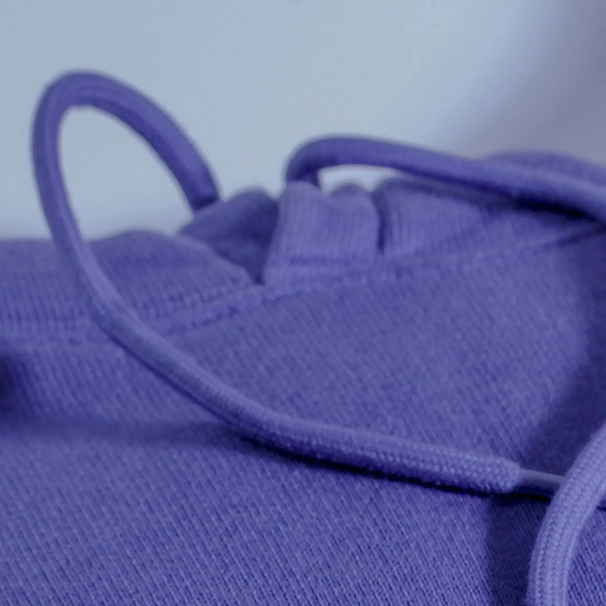 Close-up of a purple textured fabric with a blurred background