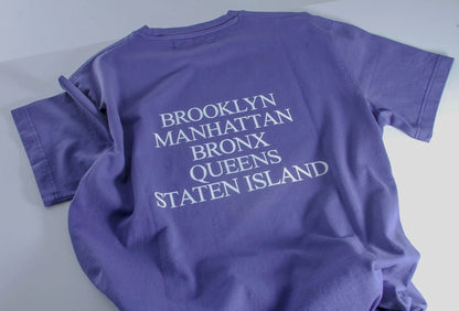 Purple t-shirt with 'Brooklyn Manhattan Bronx Queens Staten Island' text on a white background