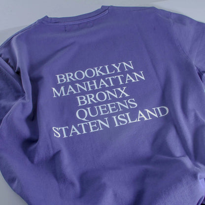 Purple sweatshirt with 'Brooklyn Manhattan Bronx Queens Staten Island' text on a light gray background