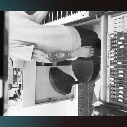 Person working with audio equipment in a studio setting